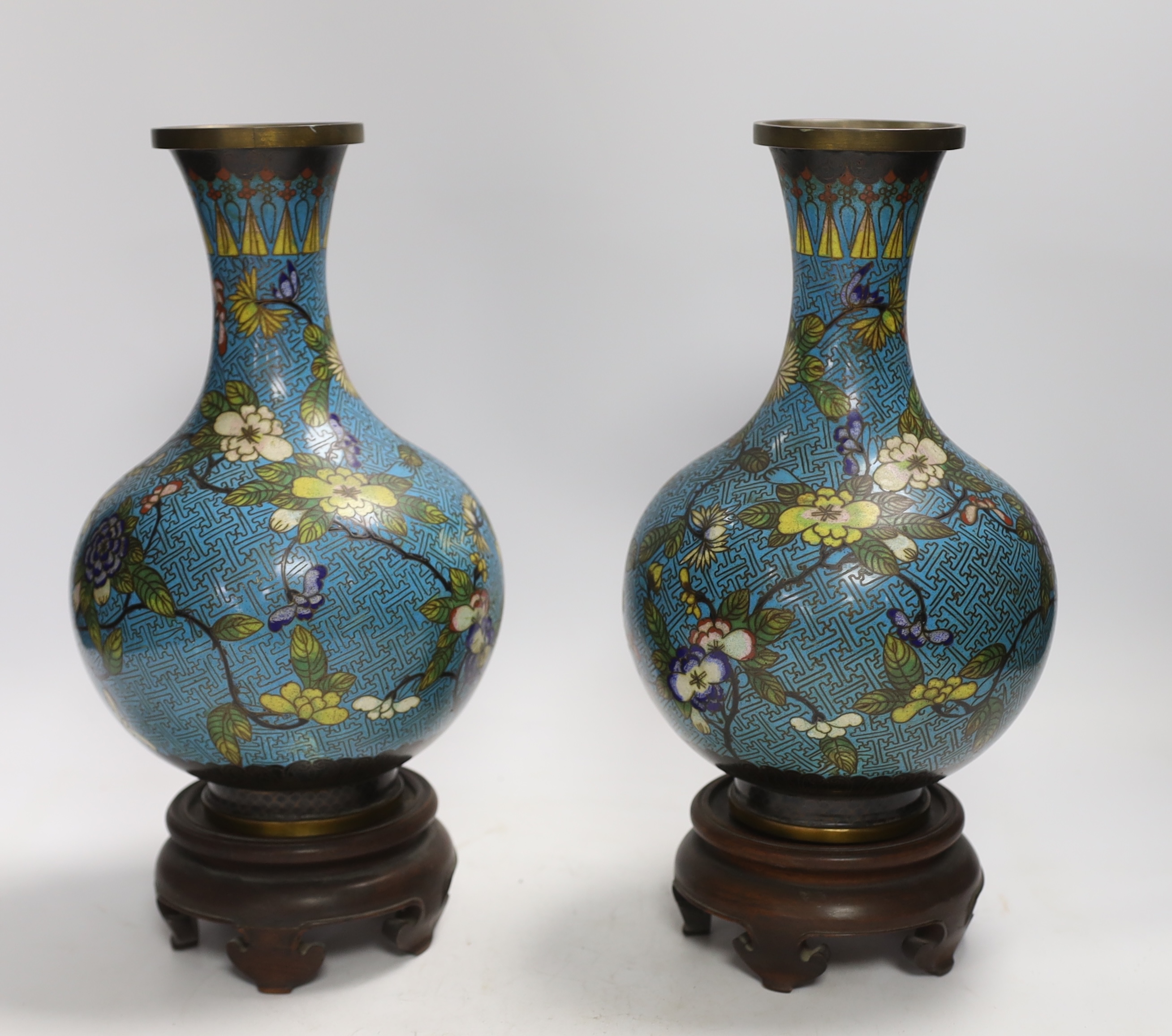 A pair of Chinese cloisonné enamel vases, late Qing dynasty, 31cm, (a.f.), on hardwood stands